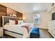 Inviting bedroom featuring a cozy king-sized bed and decorative wood accent wall at 3135 S Mojave Rd # 146, Las Vegas, NV 89121