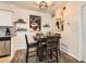 Cozy dining area with dark wood table set, decorative accents, and adjacent kitchen space at 3135 S Mojave Rd # 146, Las Vegas, NV 89121