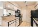 Efficient kitchen featuring white cabinets, stainless steel appliances, and convenient access to dining and living areas at 3135 S Mojave Rd # 146, Las Vegas, NV 89121