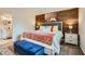 Comfortable main bedroom with modern accents, wood-look accent wall, and en-suite bathroom at 3135 S Mojave Rd # 146, Las Vegas, NV 89121