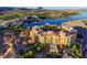 Stunning aerial view of resort-style community, golf course, lake, and residential buildings at 33 Reverie Heights Ave, Henderson, NV 89011