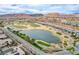 Aerial view of a community with a golf course and a serene lake at 33 Reverie Heights Ave, Henderson, NV 89011