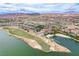 Aerial view of a community with a golf course, waterfront property, and mountain views at 33 Reverie Heights Ave, Henderson, NV 89011