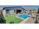 View of the backyard featuring a sparkling pool with water feature and low maintenance landscaping at 33 Reverie Heights Ave, Henderson, NV 89011