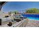 Backyard patio area featuring stylish outdoor seating and pool at 33 Reverie Heights Ave, Henderson, NV 89011