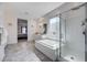 Luxurious bathroom featuring a soaking tub, walk-in shower, and double sink vanity at 33 Reverie Heights Ave, Henderson, NV 89011