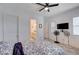 A relaxing bedroom with a ceiling fan, connecting bathroom, and natural lighting at 33 Reverie Heights Ave, Henderson, NV 89011
