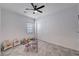 Bright bedroom with tile floors, a ceiling fan, and a sliding door closet at 33 Reverie Heights Ave, Henderson, NV 89011