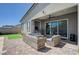 Covered patio with outdoor seating overlooking a beautiful pool at 33 Reverie Heights Ave, Henderson, NV 89011