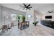 Open concept with dining area featuring rustic wooden table, views of the living room, and lots of natural light at 33 Reverie Heights Ave, Henderson, NV 89011