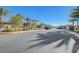 Street leading into the community with decorative rock wall entry and manicured landscape at 33 Reverie Heights Ave, Henderson, NV 89011