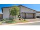 Contemporary home with a two-car garage, stylish stone accents, and low-water landscaping at 33 Reverie Heights Ave, Henderson, NV 89011