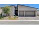Modern home with a two-car garage, low-maintenance landscaping, and tasteful exterior lighting at 33 Reverie Heights Ave, Henderson, NV 89011
