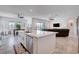 Open concept kitchen with large island, stainless steel appliances, and view into living room at 33 Reverie Heights Ave, Henderson, NV 89011
