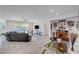 Open living room featuring modern decor, tile flooring, and a custom bar for stylish entertaining at 33 Reverie Heights Ave, Henderson, NV 89011