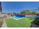 Backyard oasis with a refreshing pool, complete with a mosaic tiled water feature, and an outdoor seating area at 33 Reverie Heights Ave, Henderson, NV 89011