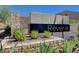 Community entrance sign beautifully landscaped with decorative rock and desert plants at 'Reverie' at 33 Reverie Heights Ave, Henderson, NV 89011