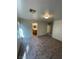 Bedroom with neutral colored walls and carpet leading to a bathroom at 3425 Palatine Hills Ave, North Las Vegas, NV 89081
