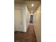 Hallway with neutral walls and carpet leads to other rooms and a door at 3425 Palatine Hills Ave, North Las Vegas, NV 89081