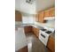 Kitchen showcasing wood cabinets, ample counter space, and modern white appliances, perfect for culinary endeavors at 3425 Palatine Hills Ave, North Las Vegas, NV 89081