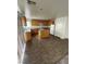 Kitchen with wood cabinets, an island, and modern appliances, enhanced by natural light from nearby windows at 3425 Palatine Hills Ave, North Las Vegas, NV 89081