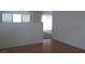 Living room features hardwood floors and lots of natural light from the windows and door at 3425 Palatine Hills Ave, North Las Vegas, NV 89081