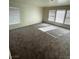 Bright, carpeted living room with multiple windows, providing ample natural light and a cozy atmosphere at 3425 Palatine Hills Ave, North Las Vegas, NV 89081