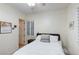 Cozy bedroom with white bedding, a ceiling fan, and natural light streaming through plantation shutters at 3540 Wisdom Ct, Las Vegas, NV 89120