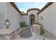 Home entrance featuring stone accents and an arched doorway with custom iron gate at 3540 Wisdom Ct, Las Vegas, NV 89120