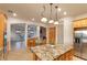 Bright kitchen features granite counters, stainless steel appliances, light wood cabinetry, and pendant lighting at 3540 Wisdom Ct, Las Vegas, NV 89120
