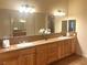 Bathroom with double sinks, a long vanity, and a large mirror at 3540 Wisdom Ct, Las Vegas, NV 89120