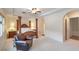 Spacious main bedroom boasts tray ceilings, a four-poster bed, and an adjoining bathroom at 3540 Wisdom Ct, Las Vegas, NV 89120