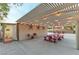 Inviting outdoor patio with pergola, string lights, and picnic tables, perfect for entertaining guests at 3540 Wisdom Ct, Las Vegas, NV 89120