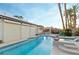 Stunning backyard pool with a tiki bar, covered grilling area, and lush landscaping offering a private oasis at 3540 Wisdom Ct, Las Vegas, NV 89120