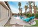 Resort-style backyard with pool, spa, tiki bar, and lounge seating surrounded by lush landscaping and palm trees at 3540 Wisdom Ct, Las Vegas, NV 89120