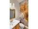 Stylish powder room featuring unique wallpaper, a modern vanity, and a framed mirror at 3540 Wisdom Ct, Las Vegas, NV 89120