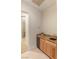 Wet bar featuring granite countertops, wooden cabinetry, a sink, and a mini fridge at 3540 Wisdom Ct, Las Vegas, NV 89120