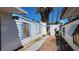 Charming home featuring a white exterior with blue accents, complemented by lush palm trees under a clear blue sky at 3717 Casey Dr, Las Vegas, NV 89120