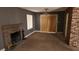 Living room featuring a fireplace, sliding door, ceiling fan and brick accent wall at 3717 Casey Dr, Las Vegas, NV 89120
