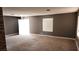 Open living area with neutral gray walls, carpet floors, and ample natural light at 3717 Casey Dr, Las Vegas, NV 89120
