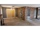 Open living area with a brick accent wall, fireplace, ceiling fan and sliding glass door to backyard at 3717 Casey Dr, Las Vegas, NV 89120