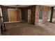 Open living area with a brick accent wall, fireplace and sliding glass door to backyard at 3717 Casey Dr, Las Vegas, NV 89120