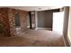 A spacious living room with a unique brick accent wall and neutral carpeting at 3717 Casey Dr, Las Vegas, NV 89120