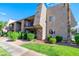 Charming condo building with stucco siding, green lawns, shrubbery, balconies, and mature palm trees at 4390 Sandy River Dr # 1, Las Vegas, NV 89103
