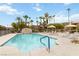 A large swimming pool surrounded by palm trees and lounge chairs at 4390 Sandy River Dr # 1, Las Vegas, NV 89103