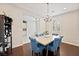 Elegant dining room with modern chandelier and seating for six at 4531 S Bay Tree Ct, Pahrump, NV 89061