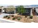 Charming single-story home with a well-maintained desert rock front yard, young trees, and a gray exterior at 4531 S Bay Tree Ct, Pahrump, NV 89061