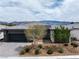 Contemporary single-story home featuring desert landscaping, a paved driveway, and mountain views at 4531 S Bay Tree Ct, Pahrump, NV 89061
