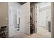 View of a bright hallway with tiled floor connecting the bathroom, closet, and laundry area at 4531 S Bay Tree Ct, Pahrump, NV 89061