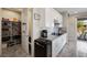 Well-lit kitchen with gray tile floors, white cabinets, stainless steel appliances, and a spacious pantry at 4531 S Bay Tree Ct, Pahrump, NV 89061